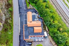 Fully fenced and secure building with pond